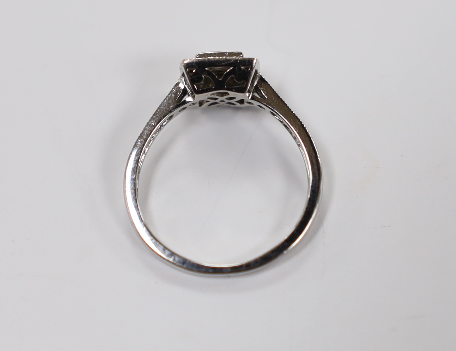 A modern 18ct white gold and diamond cluster set tablet ring, size J, gross weight 2.3 grams.